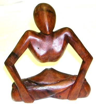 Asian carving achievement - abstract carving yogi man in yoga sitting position with hands holding legs together, middle part empty