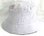 Flippable fashion cotton double sided bucket hat, one side of neutral white, and flipped over for earth tone with zipper design