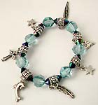 Assorted pattern motif bali silver and clear blue color beaded fashion charming bracelet, pattern including dolphin, cross, star, 2 leafs, and book 