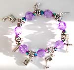 Light purple with Bali silver beaded stretchy charm bracelet with assorted pattern motif, 2 dolphins, leaf, beaded cross and arrow in heart 