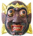 Brown evil face mask showing teeth wearing golden crown 