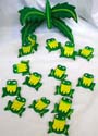 Green and yellow color painted wooden frog mobile, one green leaf on top with multi small frogs attached on