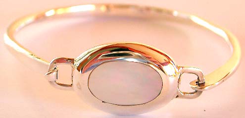 Fantasy jewelry design - Sterling silver bangle with elliptical shape white mother of pearl seashell embedded in middle