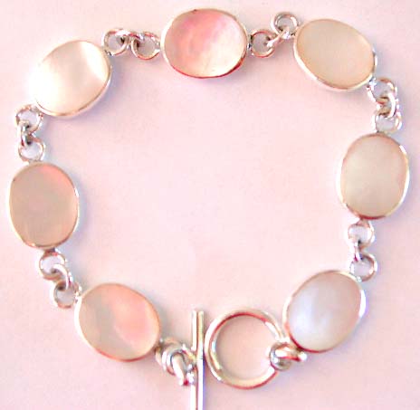 Multi rounded white mother of pearl seashell pattern forming sterling silver bracelet, toggle clasp to close