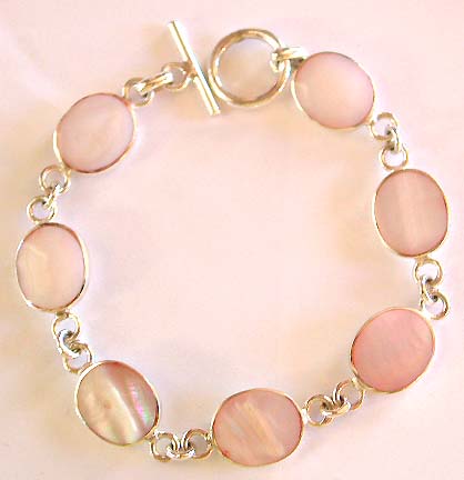 Multi oval shape white mother of pearl seashell forming sterling silver bracelet, toggle clasp to close