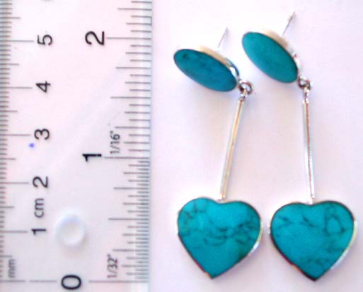 Oval shape blue turquoise stone embedded sterling silver earring holding a long strip attached heart shape blue turquoise stone on bottom