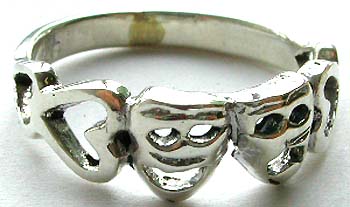 Sterling silver ring with carved-out heart-face pattern design in middle