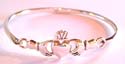 Sterling silver bangle with cut-out claudagh hand-holding-heart pattern design in middle