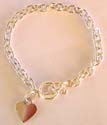 Ring loop forming sterling silver bracelet with a heart shape pendant at the end