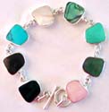 Assorted genuine stone embedded irregular shape pattern forming sterling silver bracelet, toggle clasp to close
