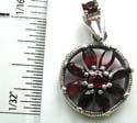 Multi mini marcasites stone embedded cut-out circle pattern sterling silver pendant with multi garnet stone forming flower pattern in middle
