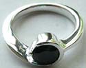 Curved-in pattern design sterling silver ring holding a rounded black cz stone in middle