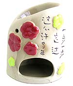Ceramic oil warmer with red yellow flower and carved feet pattern and Chinese phrase means 'Every step that you took in these years' 