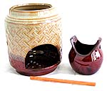 Oriental double pot style ceramic oil burner with mud tone carved out retan pattern and a wooden stick