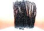 Black beaded multi strings forming fashion bracelet with button end
