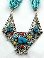 Tibetan style, tribe fashion necklace with multi blue beaded strings and beaded metal pendant with 4 mini bells on bottom