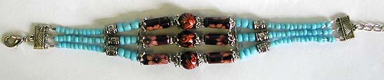 Ethnographic jewelry of Tibertan bracelet with imitation coral round beads and multiple strings of seedbeads