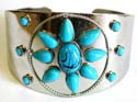 Fashion bangle bracelet with turquoise stone forming flower pattern design in middle 