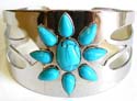 Fashion bangle bracelet with turquoise stone forming flower pattern design in middle and carved-out pattern on both sides