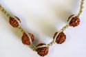 Fashion hemp string necklace and bracelet set with red full nuts embedded in middle, bead loop to close
