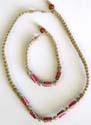 Fashion necklace and bracelet set with dark pink beads embedded in middle, bead and double loop to close