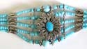 Multi light blue beads forming 5-strings fashion bracelet with turquoise stone embedded flower pattern set in middle