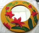 Rounded yellow wooden mirror with red lily flower decor