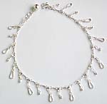 Sterling silver anklet with loop pattern and a mini bell at the end