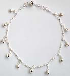 Sterling silver anklet with star and shell pattern, a mini bell at the end