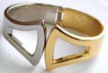 Fashion bangle bracelet in gold and silver 2-tone design with carved-out double fan shape decor at center