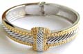 Gold and silver 2-tone fashion bangle in carved-in line pattern design with a loop knot decor at center