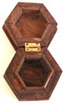Octagonal deep brown wooden box with carved pattern design on top 