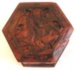 Octagonal deep brown wooden box with carved pattern design on top 