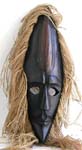 Black sharp man face wooden mask with rope hair and empty eye hole
