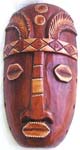 Long nose brown wooden mask with carved-in eyes and mouth and pattern decor on forehead