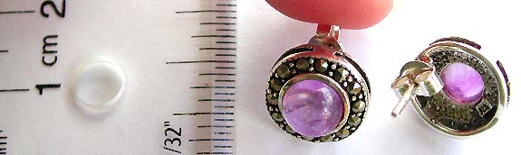 Circular sterling silver stud earring with multi marcasite stone surrounded purple color bead at center       
