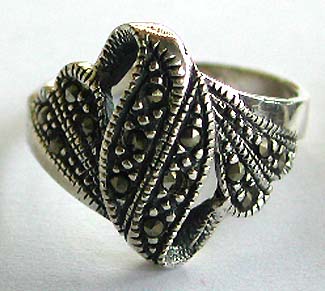 Sterling silver ring with multi marcasite stone embedded carved-out mystic pattern decor at center and multi marcasite stone on both sides

  




