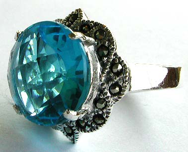Gemstone rings and silver rings for bulk purchase. Marcasite 925 sterling silver ring holding a rounded blue cz stone in middle  

