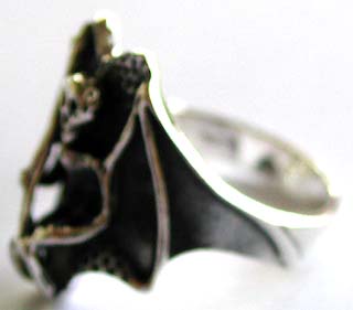 925. sterling silver ring with carved-out black flying skeleton with stick pattern decor at center