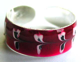 Red enamel sterling silver toe ring with mini black and white floral pattern decor around                 
