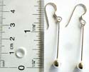 Fish hook silver earring with long strand hanging down and a round bead at the end