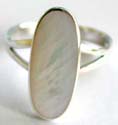 Sterling silver ring with carved-out V shape pattern holding an elliptical shape white mother of pearl seashell in middle