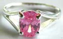 Carved-out V shape pattern sterling silver ring holding an oval shape pink color cz stone at center