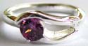 925. sterling silver ring with carved-out double wavy pattern hodling a rounded amethyst stone in middle 