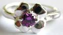 Central flower pattern design sterling silver ring with a mini rounded red garnet stone / amethyst stone embedded in middle