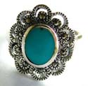 An oval shape blue turquoise stone inlay sterling silver ring with multi marcasite stones embedded carved-out flower pattern decor at center