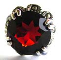 Multi marcasite stone embedded flower pattern decor 925. sterling silver ring holding a rounded red garnet stone in middle