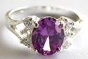 Sterling silver ring with an oval shape purple cz stone embedded at center and 3 mini clear cz stone on each side