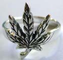 Sterling silver ring with carved-out maple leaf pattern decor in middle