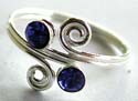Sterling silver toering in double spiral pattern design holding 2 dark blue cz stone in middle